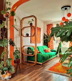 a living room filled with furniture and lots of plants