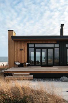 a wooden deck in front of a house on the beach