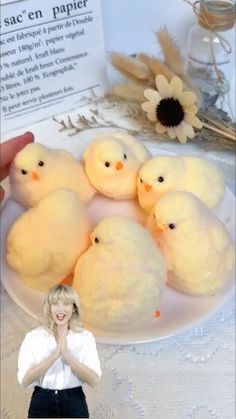 a woman standing in front of a plate filled with peeps on top of a table