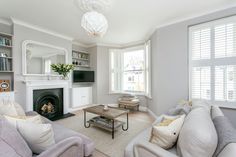 a living room filled with furniture and a fire place