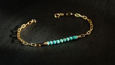 Turquoise * Opal * Bracelet  This bracelets features a tiny set of 8 semi - round genuine Kingman Turquoise paired with a touch of 2 delicate Ethiopian Opals on a vibrant 14k gold filled paperclip chain.  Wear it solo for a minimalist look or stacked with your favorite pieces for a more personalized style. Each bracelet includes a 1 inch chain extender + freshwater pearl charm. M A T E R I A L S : * Chain - 14k Gold Filled Paperclip Chain * Bead Size - 3 - 4mm Kingman Turquoise, 3 - 3.5mm Ethiopian Opals * Bead Bar Size: Approx. 1.5 inches D E T A I L S :  Bracelet Length  * 6 inches  * 6.5 inches                                                                     * 7 inches                                         * 7.5 inches                                      * If you require a specifi Bead Bar, Chain Extenders, Opal Bracelet, Kingman Turquoise, Trombone, Bar Bracelets, Pearl Charms, Genuine Turquoise, Paper Clip