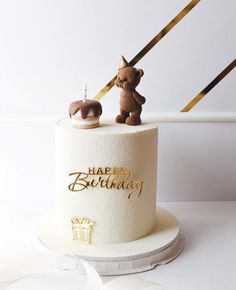 a birthday cake with two teddy bears on top