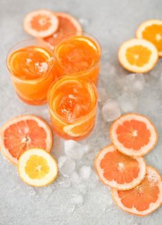 oranges and lemon slices are arranged on ice