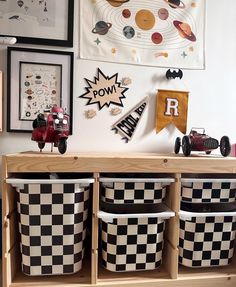 the wall is decorated with pictures, toys and other things in black and white checkered baskets