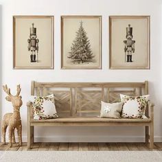 a wooden bench sitting in front of three framed pictures on the wall next to a christmas tree