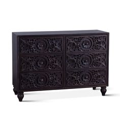 an ornate carved wooden cabinet with four drawers