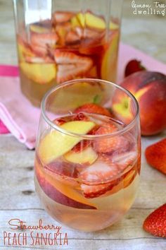 a glass filled with fruit sitting on top of a table