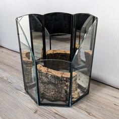 a glass vase sitting on top of a wooden floor