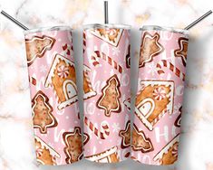 two pink tumblers with gingerbread cookies on them