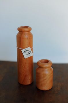 two wooden vases sitting next to each other on a table