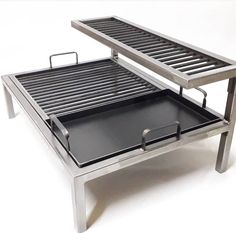 a metal table with two trays attached to the top and one on each side