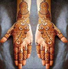 two hands with henna designs on them