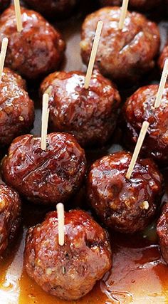 meatballs with toothpicks on them are being cooked in the oven for consumption