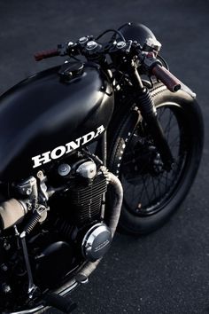 a black motorcycle parked on top of a parking lot