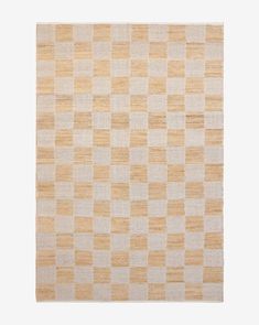 an orange and white checkered rug on a white surface with no one in it