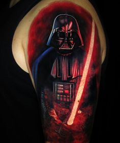 a man with a tattoo on his arm has a darth vader painting on it