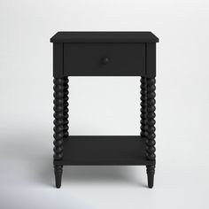 a small black table with two drawers on one side and an open drawer on the other