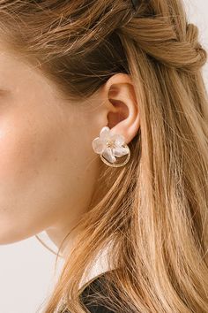 The Daisy One by One Gold Hoop offers a fresh take on the usual plain, gold hoop. The addition of a delicate daisy flower made of acrylic lends the earrings a ethereal feel that is at once bold and whimsical. This unique design captures the seemingly opposing strong and soft sides of human nature to provide a beautiful pair of earrings. Perhaps best of all, the gold hoop and flower can be worn together or separately. The unique construction provides you with two earrings in one. Pair them togeth Trendy Flower Earrings For Wedding, Trendy Flower-shaped Earrings For Wedding, Spring Flower Hoop Earrings For Pierced Ears, Spring Hoop Earrings With Flower Charm, Gold Feminine Flower Earrings With 3d Flowers, Feminine Spring Flower Charm Earrings, Feminine Flower Charm Earrings For Spring, Feminine Spring Flower Earrings With Flower Charm, Delicate Flower-shaped Hoop Earrings