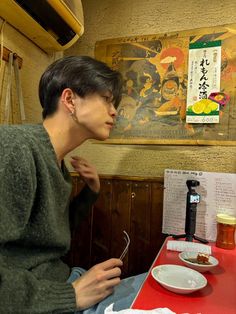 a woman sitting at a table with food in front of her and looking off into the distance