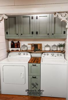 a white washer and dryer sitting in a kitchen next to wooden counter tops