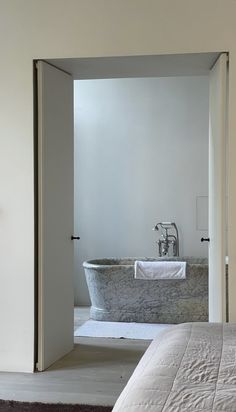 a bath tub sitting in the middle of a bedroom