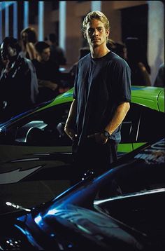 a man standing in front of some cars