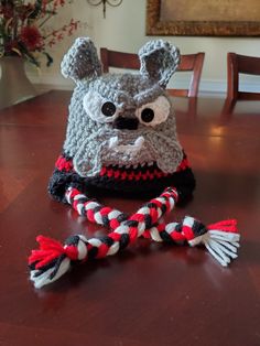 a crocheted hat sitting on top of a wooden table