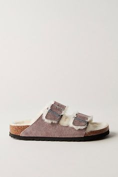 In an irresistibly luxe design, this cozy Birkenstocks are handcrafted with a shearling-lined footbed and suede straps. Traditional two-strap design with adjustable buckle closures and textured EVA soles. **Fit:** Narrow A-B width. A Birkenstock narrow width fit is comparable to a Medium (B Width). **Fit Note:** This style runs true to size, if in between sizes; we suggest sizing up. | Arizona Shearling Birkenstock Sandals at Free People in Purple, Size: EU 39 Shearling Birkenstock, Shearling Sandals, Luxe Design, Birkenstock Sandals, Purple Suede, Birkenstock Arizona, Strap Design, Boho Outfits, Birkenstock