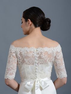 the back of a woman's wedding dress with an off - shoulder lace top