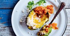 an eggplant stuffed with meat and garnished with parsley on a white plate