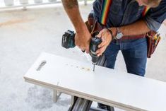 a man using a driller on a table