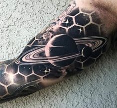 a man's arm with an image of the planets and stars on it