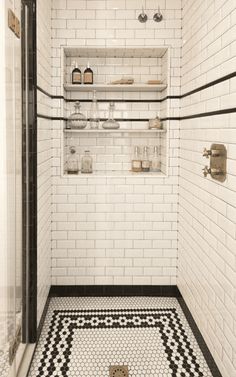 a black and white tiled bathroom with shelves