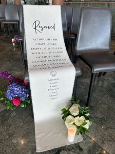 a memorial with flowers and candles on the ground next to a white banner that reads, reserved