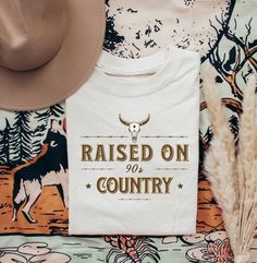 Raised on 90's Country Music Tshirt.  👕Lightweight soft fabric with high quality dye image ❌ Do Not Tumble Dry  ✅ Wash on a low heat & not not iron directly over image 👕Printed on front of tshirt. If you would like it on the back please send us a message.  📏Size:                      S           M             L        XL Chest (to fit):  34/36    38/40    42/44   46/48   Size:                   XXL       3XL      4XL         5XL Chest to fit:   50/52    54/56    58/60    62/64    ✈️ International delivery available 📮Sent via Royal Mail 24 or 48hr tracked delivery. Delivery details will be sent when item is dispatched. ‼️ Please note all orders are processed within 5 working days & then the postage time is on top of this. ‼️📮PLEASE BE AWARE INTERNATIONAL SHIPPING CAN TAKE 5-6 WEEKS AFT Cotton T-shirt With Letter Print For Country Festivals, White Graphic Tee For Country Concerts, Country Music Shirt Ideas, Summer T-shirt With Screen Print For Country Concerts, White Band Merch T-shirt For Country Concerts, Retro T-shirt For Country Concerts In Summer, 90s Country Shirt, Raised On 90s Country, Cotton Graphic Print T-shirt For Country Concerts