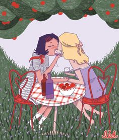 two women sitting at an outdoor table kissing