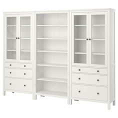 two white bookcases with drawers on each side