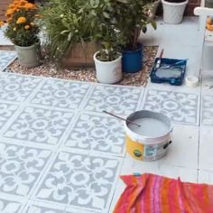 an outdoor patio with cement pavers and potted plants on the ground next to it