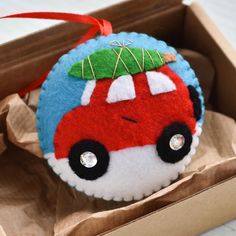 a red car ornament sitting in a box