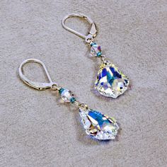 "Gorgeous Swarovski crystal earrings are made with faceted clear AB Swarovski crystal baroque pendants accented with teal seed beads. The AB element catches and reflects the color around the crystal. They dangle 1\" (2.5 cm) from sterling silver lever backs. ❖ Swarovski crystal ❖ glass seed beads ❖ sterling silver Earrings shown are on lever backs. All earring types are sterling silver with the exception of clip-ons, which are silver plated." Swarovski Crystal Earrings, Gold Filled Earrings, Austrian Crystal, Jewelry Cleaner, Crystal Earrings, Jewelry Care, Sterling Silver Earrings, Swarovski Crystals, Silver Earrings