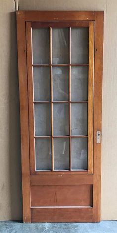 a wooden door with glass on the side