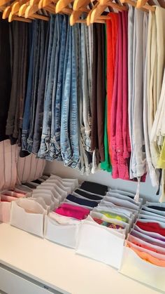 an organized closet with jeans and t - shirts