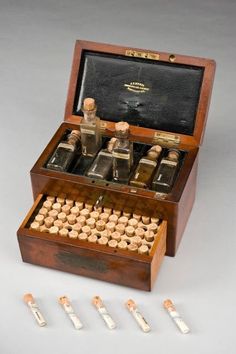 an old wooden box with several bottles in it