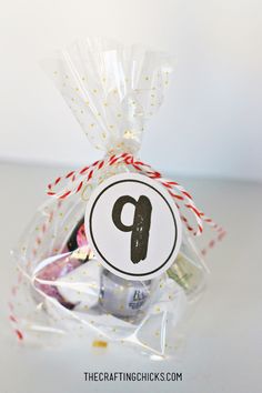 a bag filled with candies and candy on top of a white table next to a sign that says p