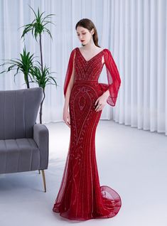 Sleek and sophisticated, this red prom dress is a showstopper designed to make you feel like a star. The gown features a deep V-neckline that elegantly frames your face and neckline, while the flowing, sheer sleeves add a touch of romantic drama. Intricate beadwork adorns the bodice and skirt, creating a dazzling pattern that catches the light beautifully. The fitted silhouette accentuates your curves, and the floor-length skirt flows gracefully, adding a sense of movement and elegance. Perfect Sleeve Prom Dresses, Gown Outfit, Prom Dress Burgundy, Prom Dresses Burgundy, Beaded Mermaid, V Neck Prom Dresses, Mermaid Sequin, Quinceanera Dress, Corset Bodice