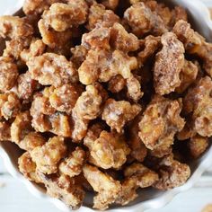 a white bowl filled with nuts on top of a table