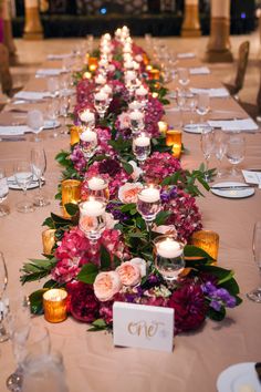 a long table is set with candles and flowers for a formal dinner or banquet event