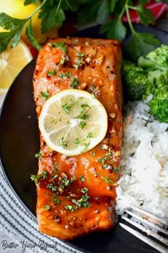 a plate with salmon, rice and broccoli on it