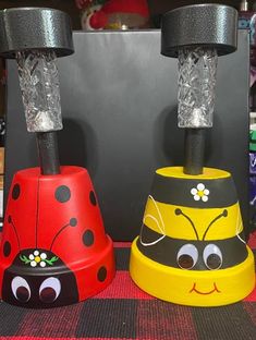 two ladybug lamps sitting on top of a table