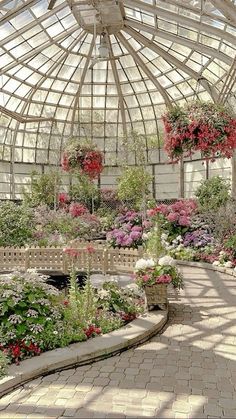 the inside of a greenhouse filled with lots of flowers